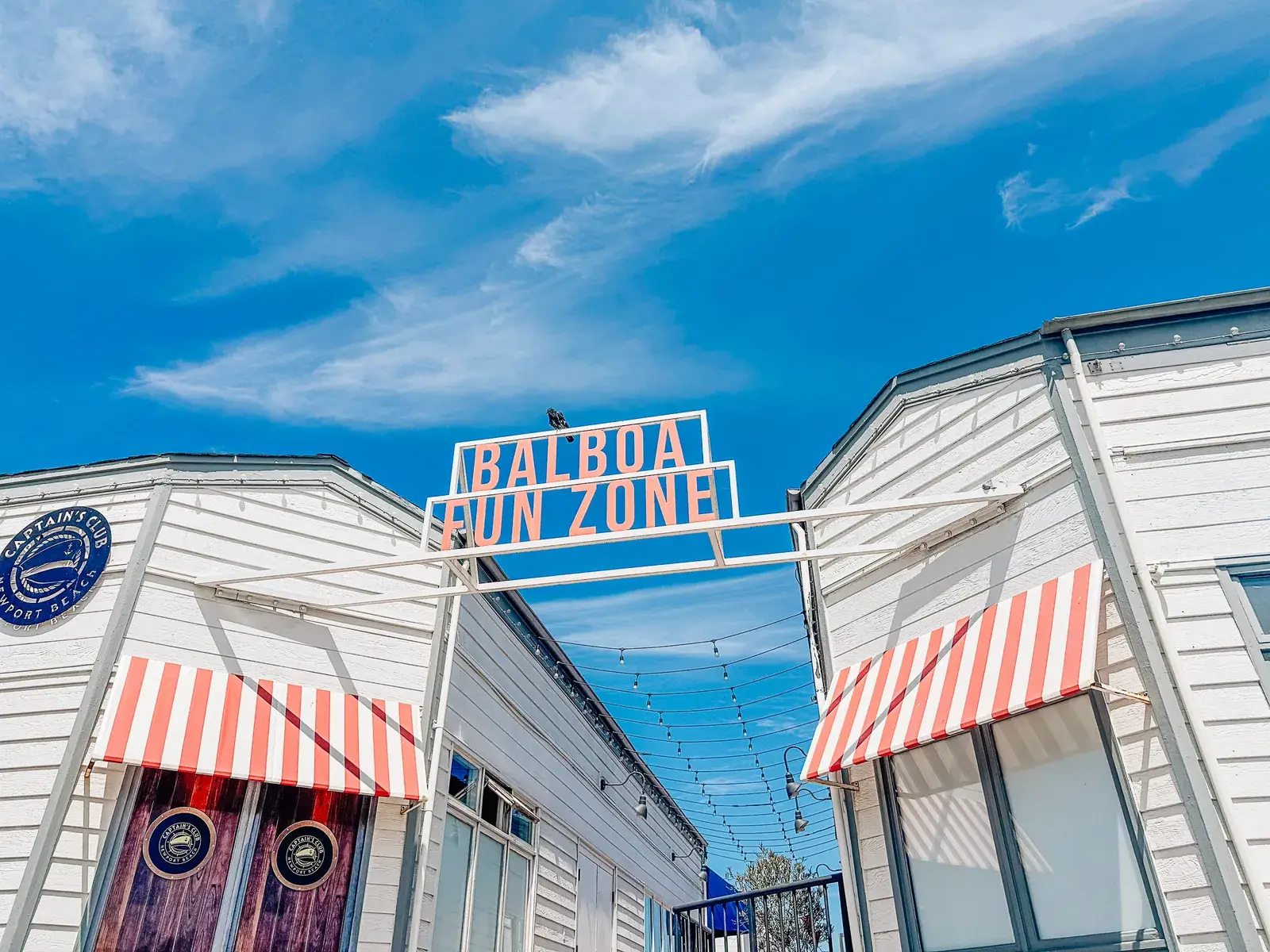 The entrance of the Balboa Fun Zone in Newport Beach under a blue sky