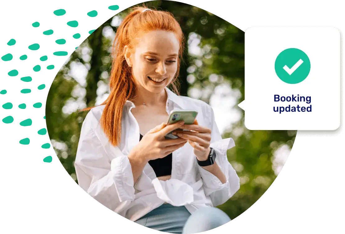 A woman looking at her phone outdoors, with a notification beside her reading Booking updated