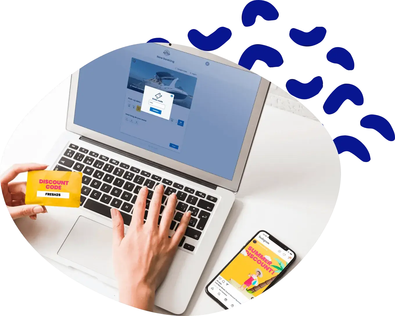 Hands at a laptop showing a discount code, with a phone beside it