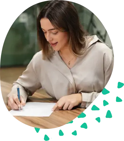 A woman signing a document at a table