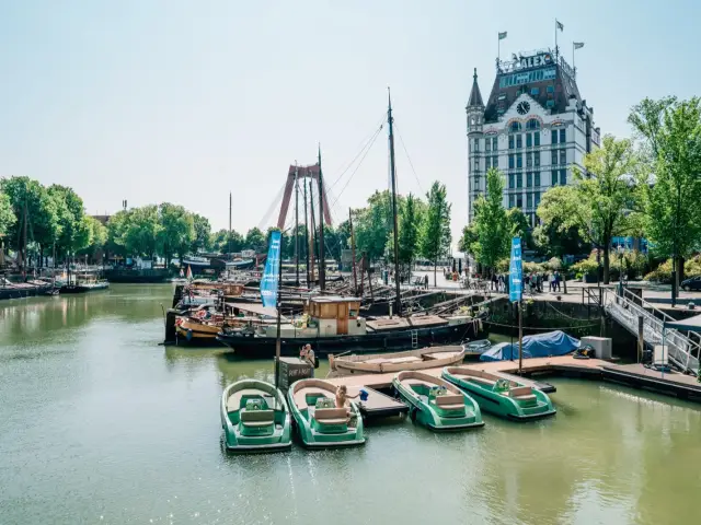 A row of open rental motorboats moored together in Rotterdam