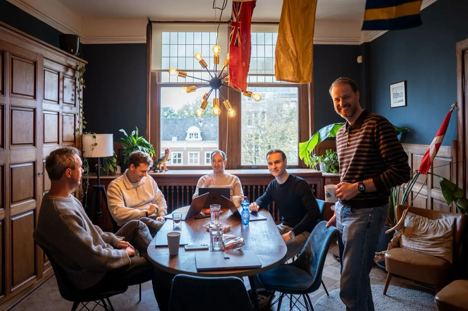 Part of the Let's Book team at the table in the office on the Herengracht in Amsterdam