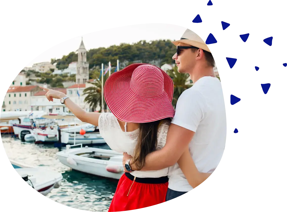 A couple looking out over a harbor, one of them pointing